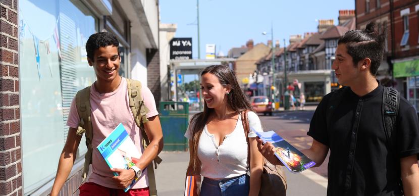 3 students talking together in the street