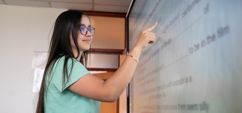 student touching a screen