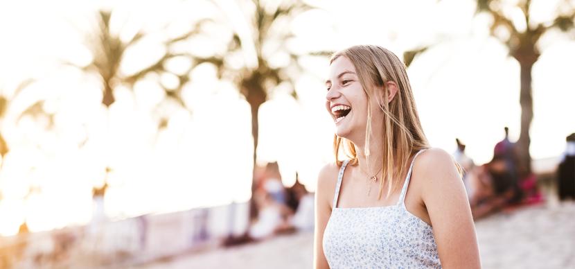 girl laughing on the beach