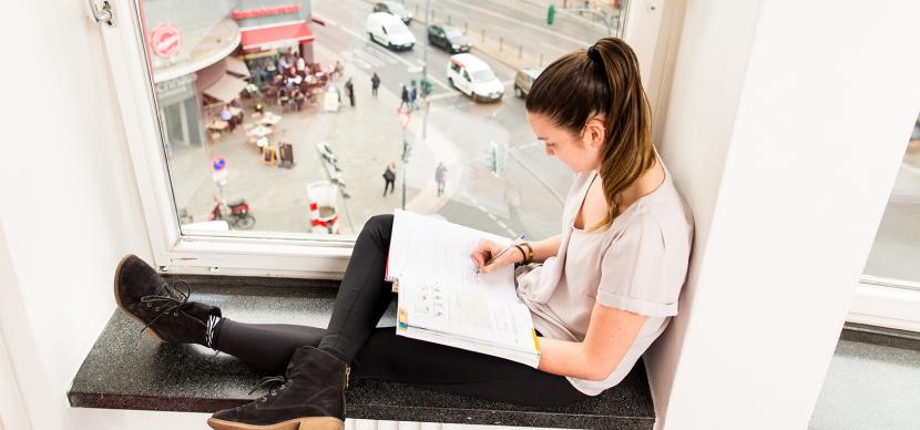 student writing in her notebook