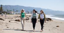 3 students walking on the beach