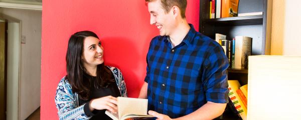 students looking at a book together