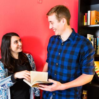 students looking at a book together