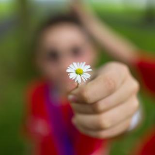 student holding a flower