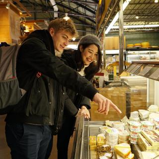 students looking at food in a market